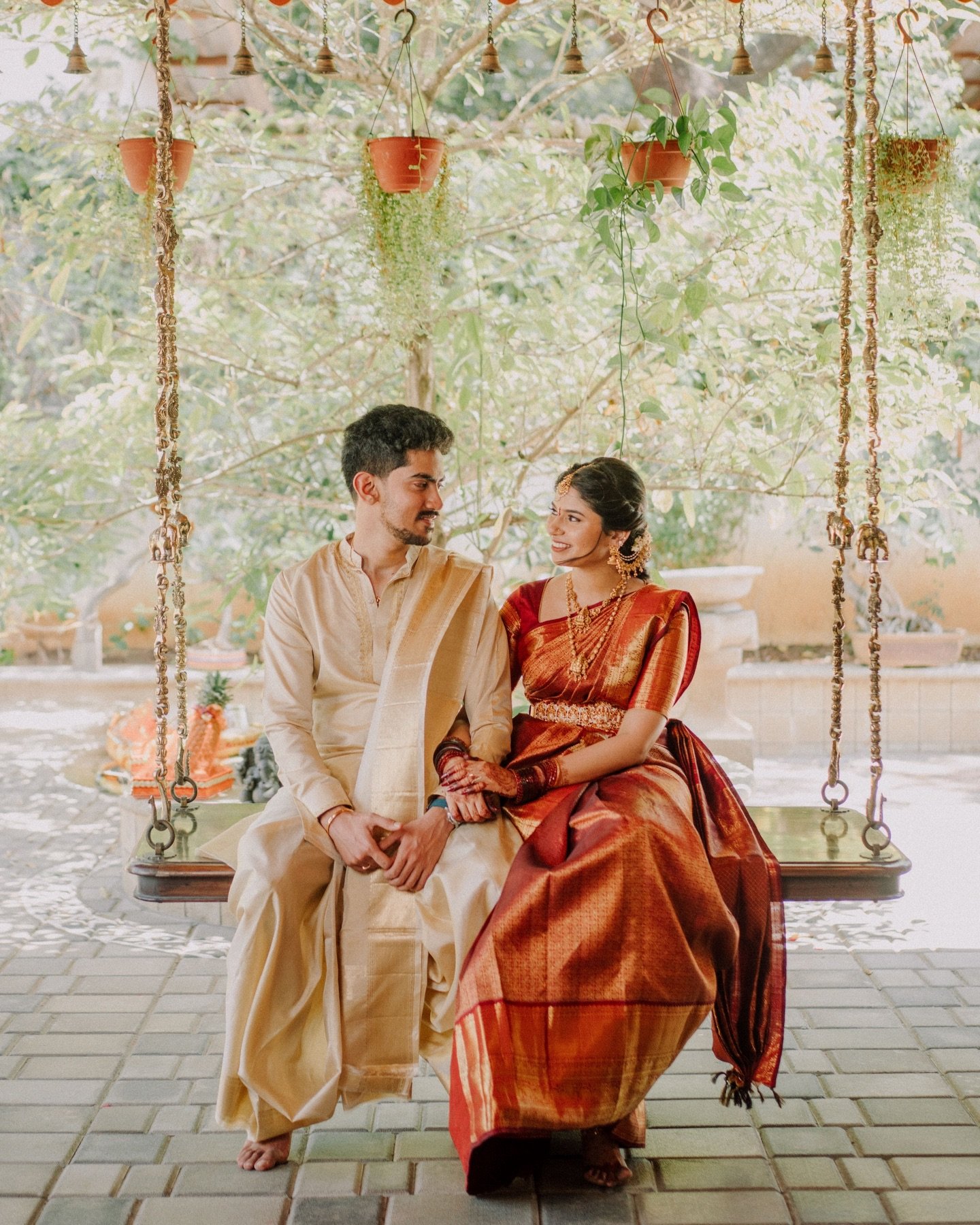 A couple seated together on a garden swing